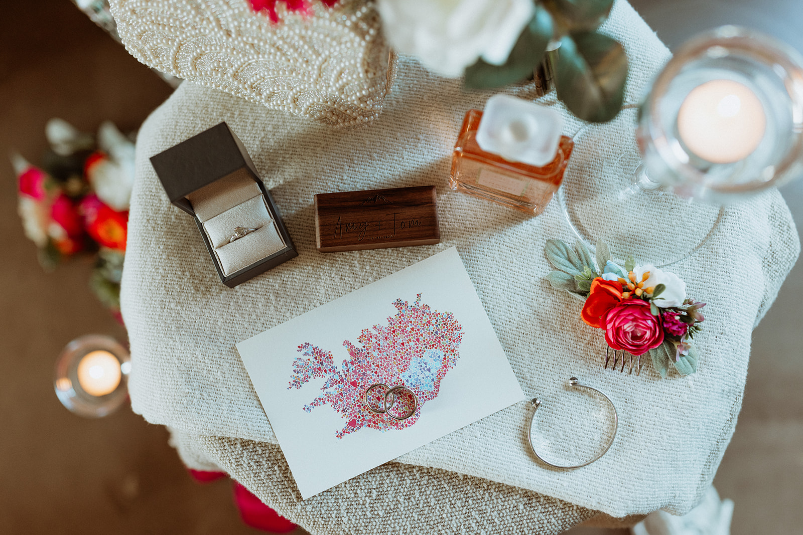Close-up of Amy’s handcrafted wedding rings from Amy Paul Jewellery, placed alongside delicate wildflowers and Icelandic scenery at Eirð Retreat.