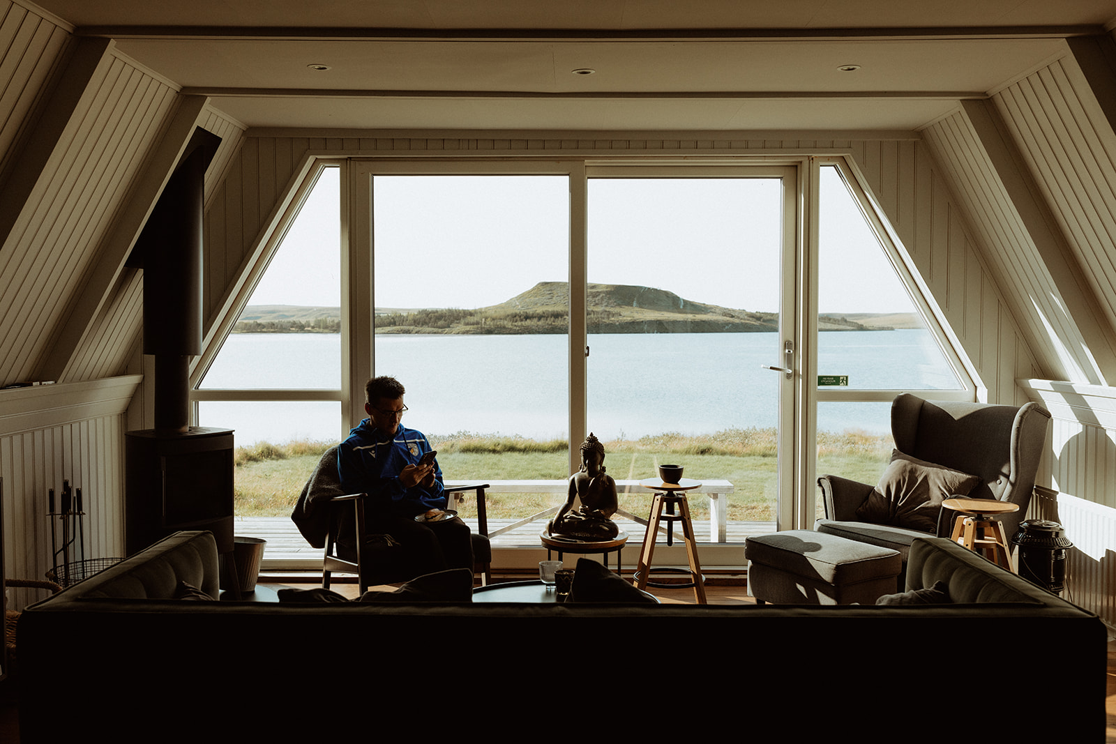Stunning panoramic view from Eirð Retreat, overlooking the tranquil lake and surrounding Icelandic landscapes.