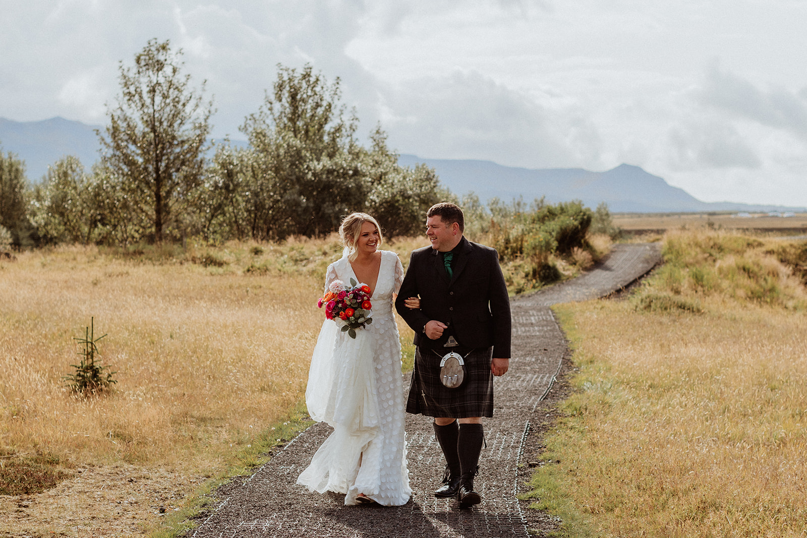 Bride and her father arriving at the wedding ceremony location in Iceland, ready to begin their emotional elopement at Gluggafoss waterfall.