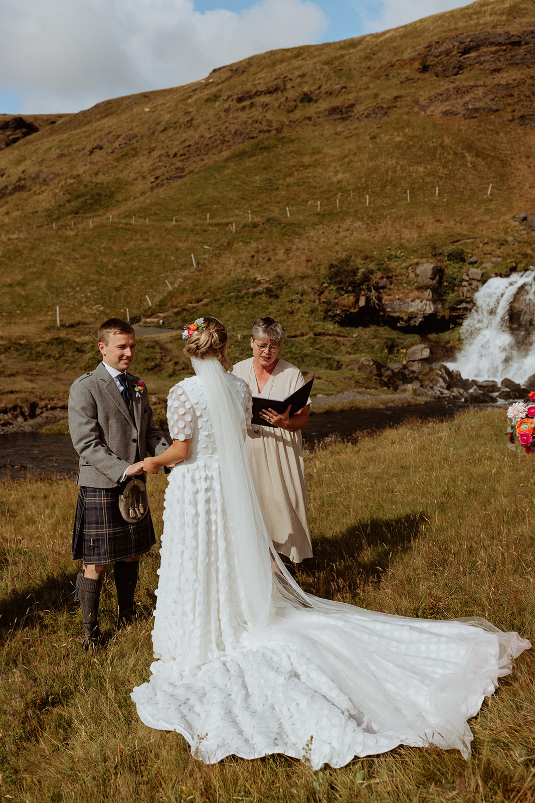 Bride and groom exchanging heartfelt vows during their intimate Icelandic elopement at Gluggafoss waterfall.