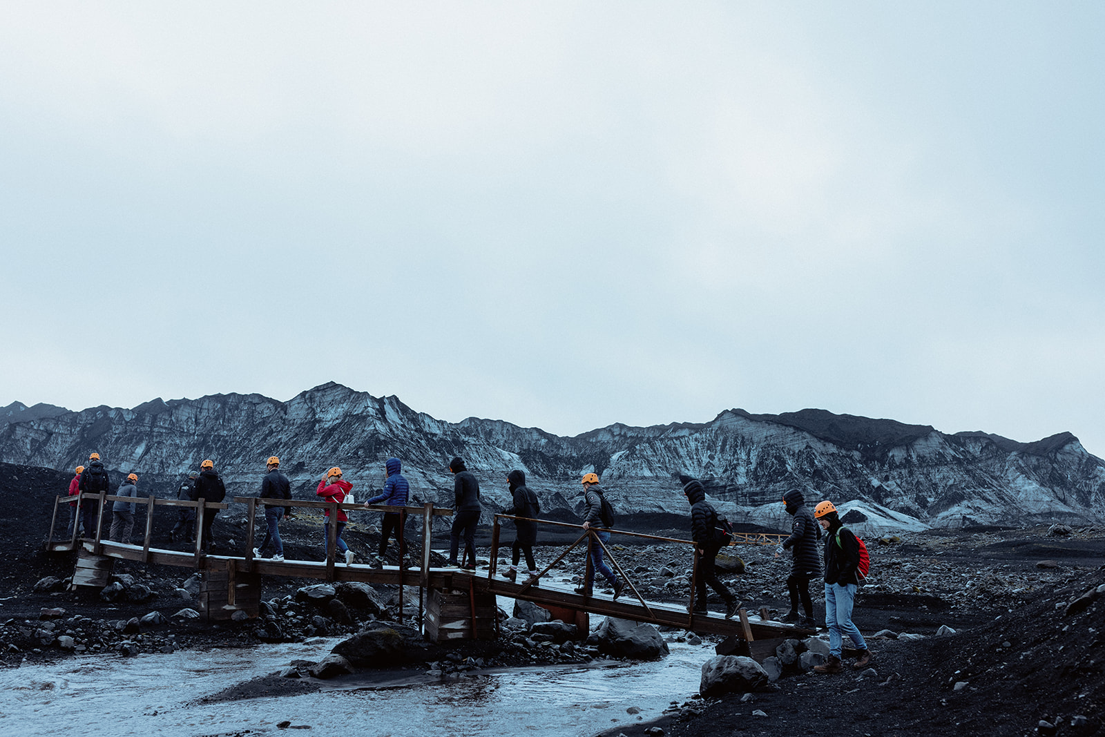 Amy and Tom on the Katla glacier hike, with snow flurries in the distance adding a magical atmosphere.