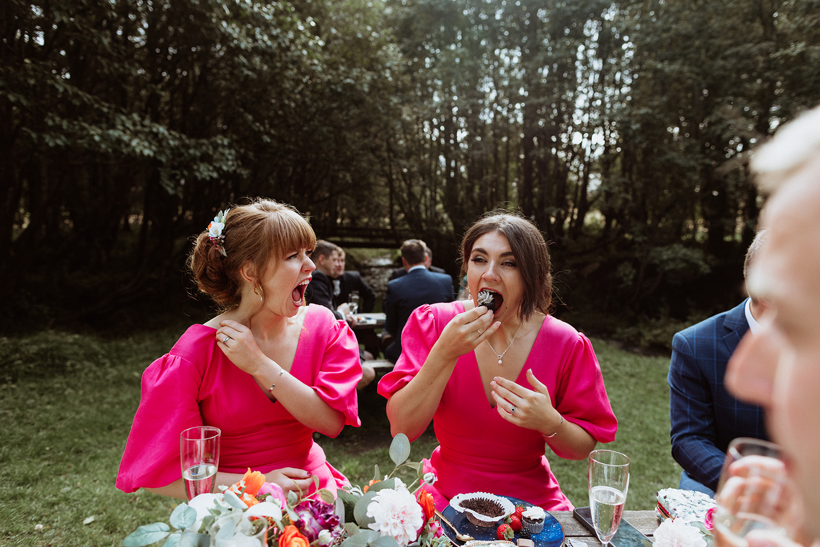 Bridesmaid enjoying a slice of cake during the Iceland elopement celebration at Thornsteins Grove.
