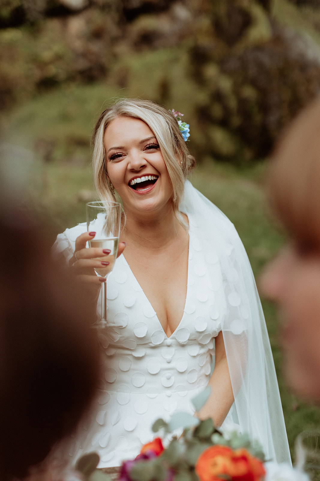 Bride laughing with joy during her Iceland elopement at Thornsteins Grove, surrounded by stunning landscapes.