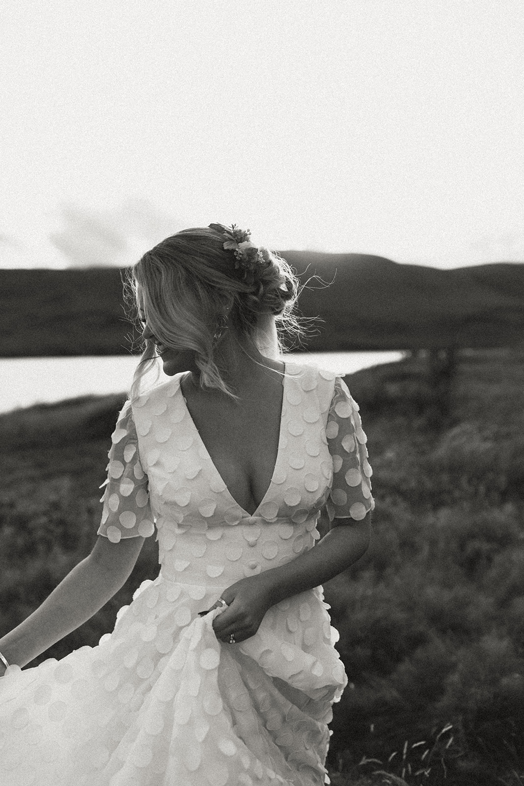 Bride running through the Icelandic landscape, her wedding dress flowing in the wind, capturing the spirit of freedom and adventure in her elopement.
