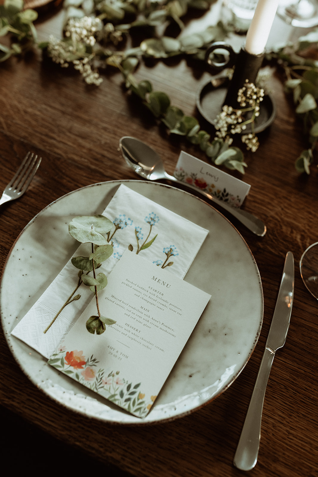 Close-up shot of the elopement menu on a rustic wooden table, beautifully designed for the intimate Icelandic wedding at Eirð Retreat, with a fine dining touch