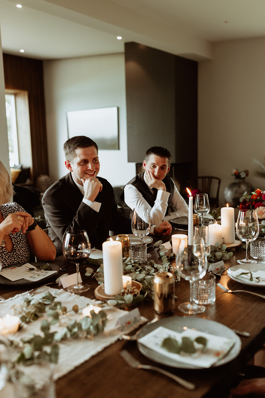 Guests enjoying the intimate dining experience at Eirð Retreat during the Icelandic elopement celebration, seated at the elegantly set table with a beautiful view of the surrounding landscape