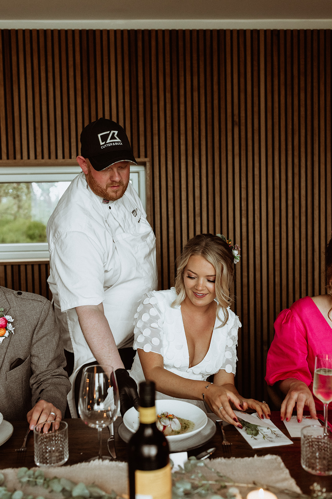 Private chef serving the bride during the intimate Icelandic elopement reception at Eirð Retreat, showcasing a personalised dining experience.