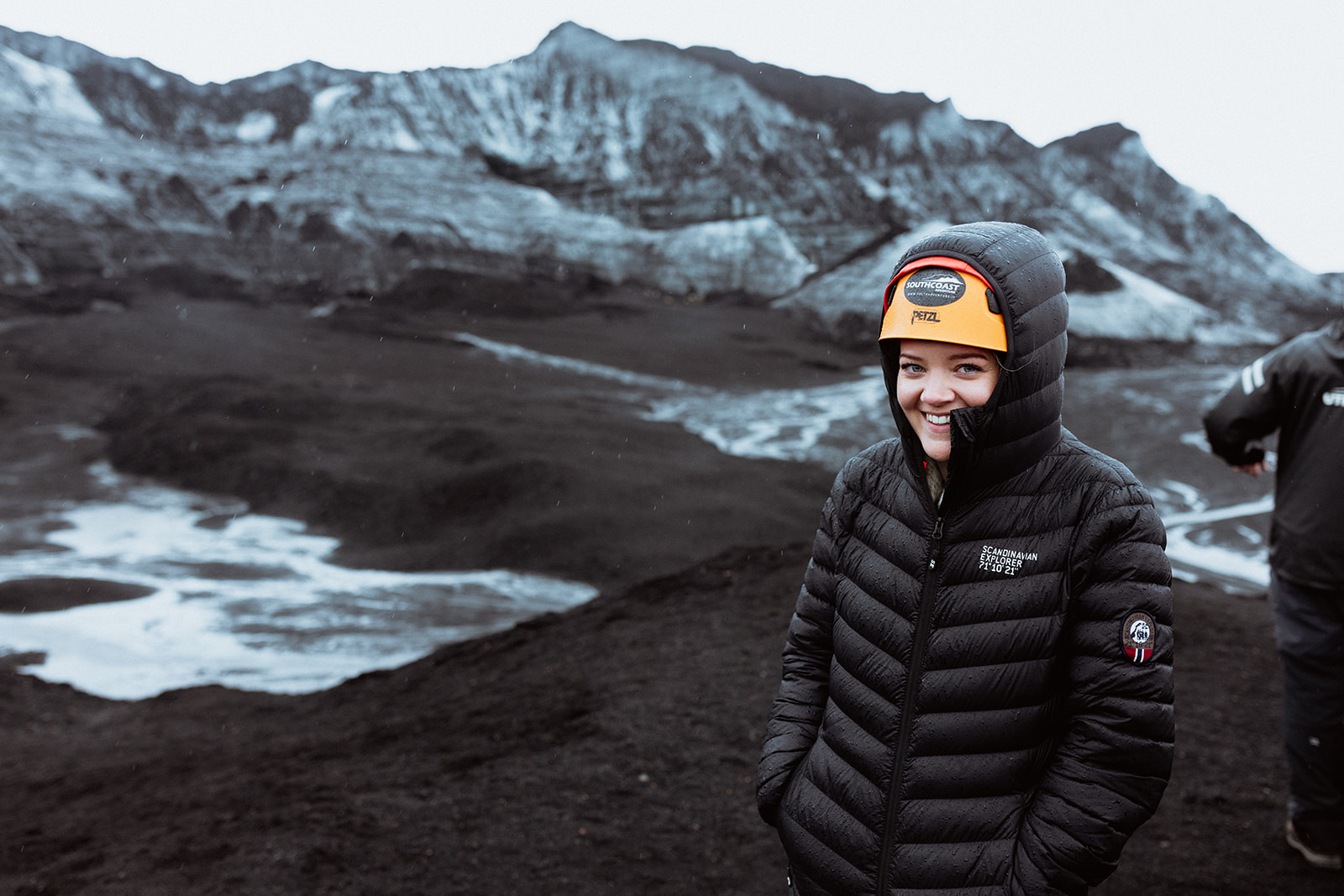 Bride standing on the icy surface of Katla glacier, surrounded by dramatic ice formations and volcanic landscapes.