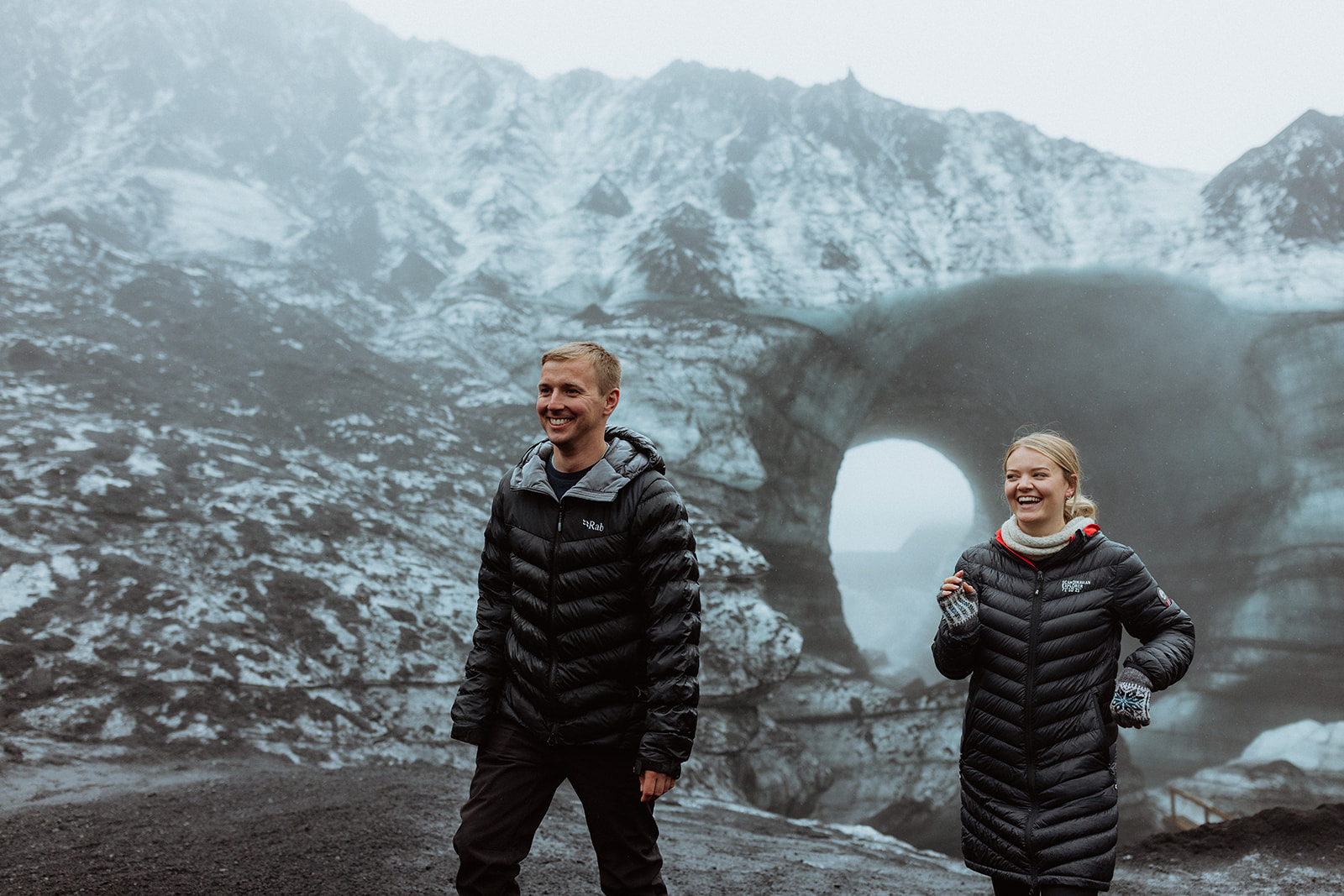 Amy and Tom standing against the vast backdrop of Katla glacier, with the icy landscape stretching far into the distance