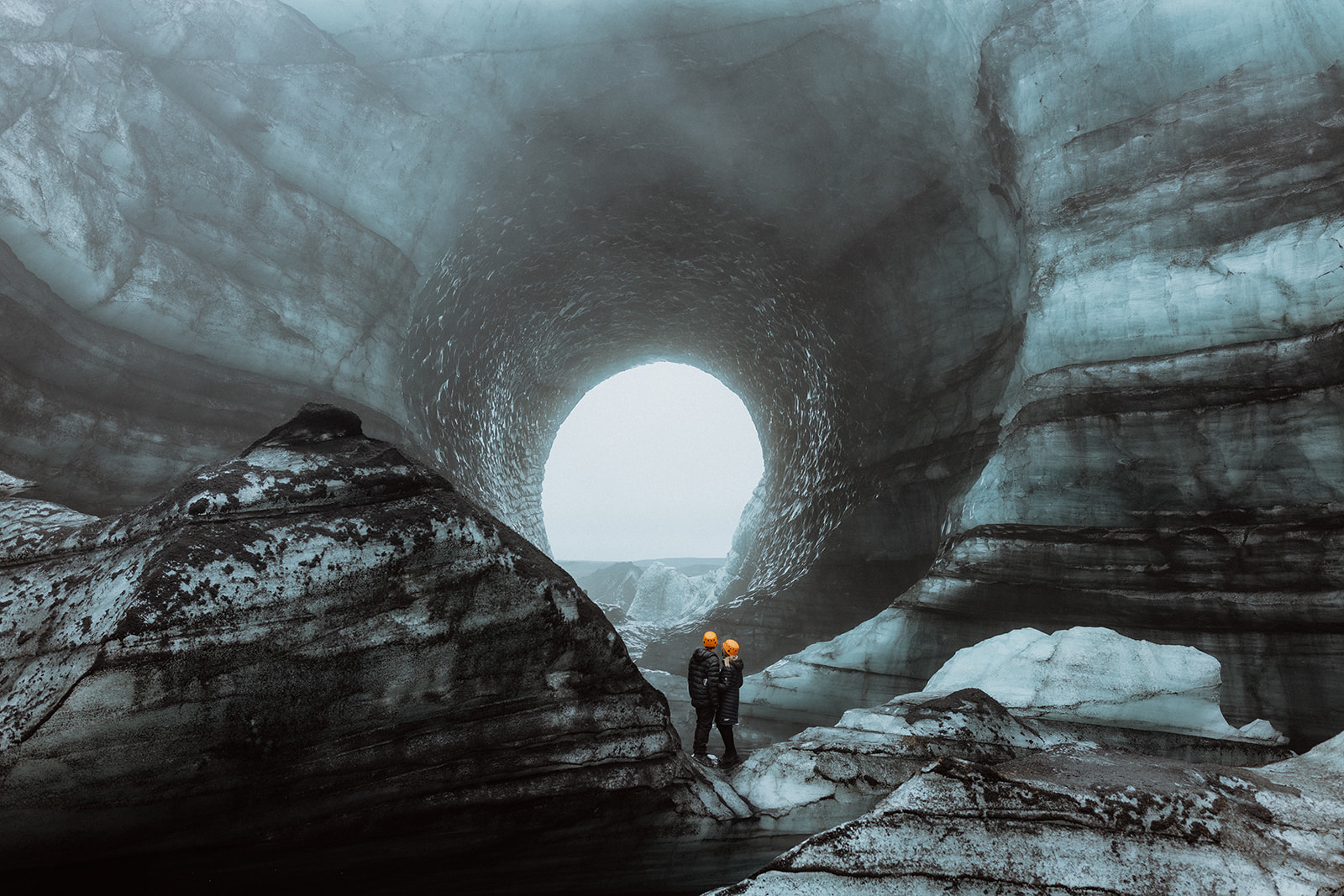 "Amy and Tom walking along a ridge on Katla glacier, with dramatic views of the glacier and volcanic landscapes beneath them.