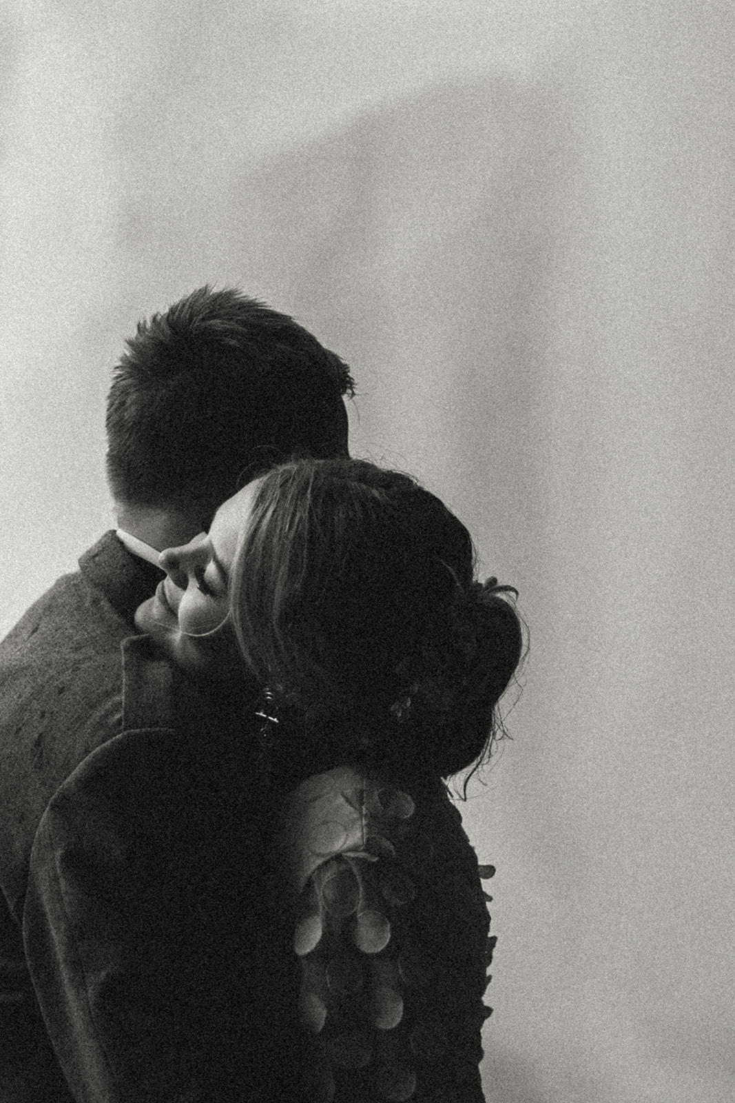 Newlyweds sharing their first dance beneath the mist of a stunning Icelandic waterfall