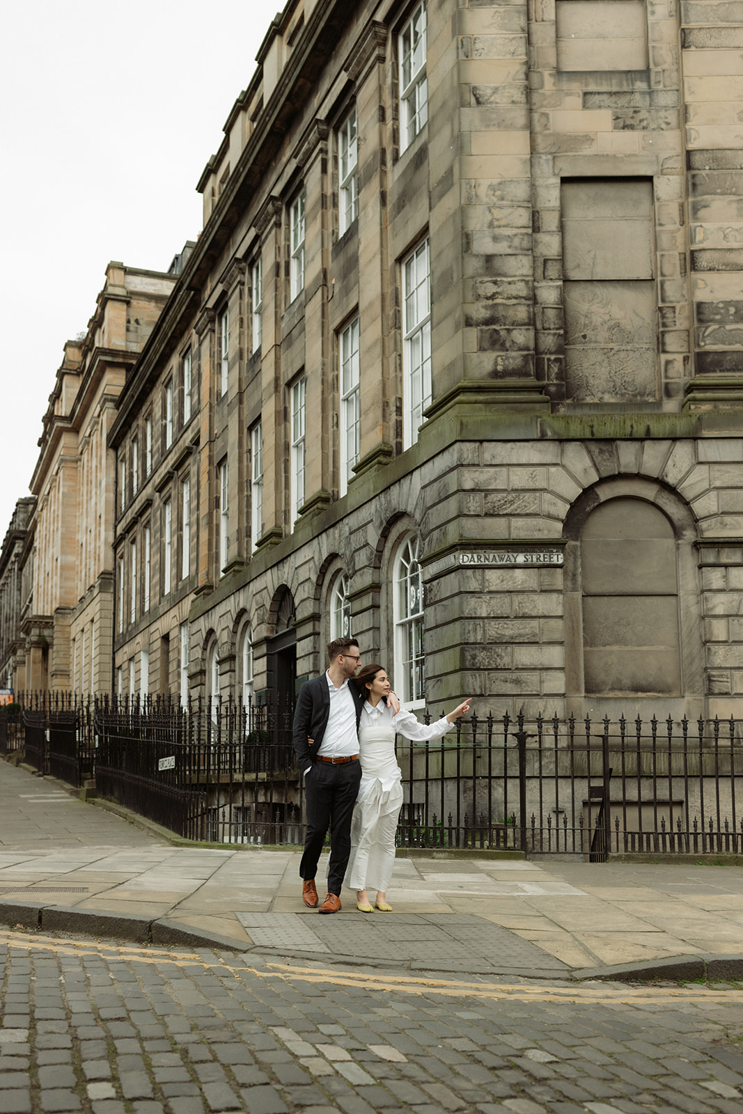 Documentary engagement session in Edinburgh, capturing a couple walking through the city’s picturesque streets