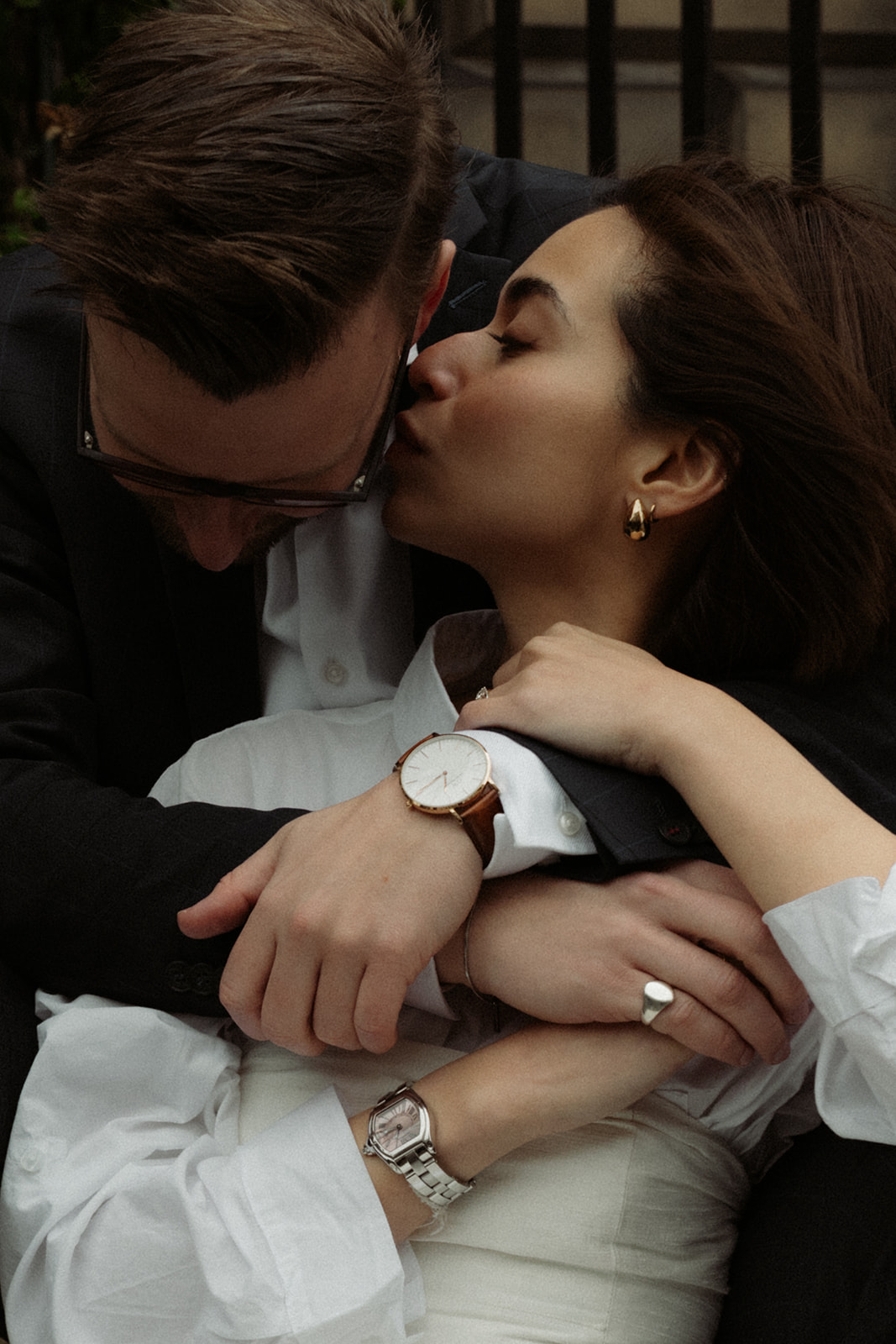 Editorial-style engagement session in Edinburgh featuring a couple sharing a quiet moment while walking through the city.