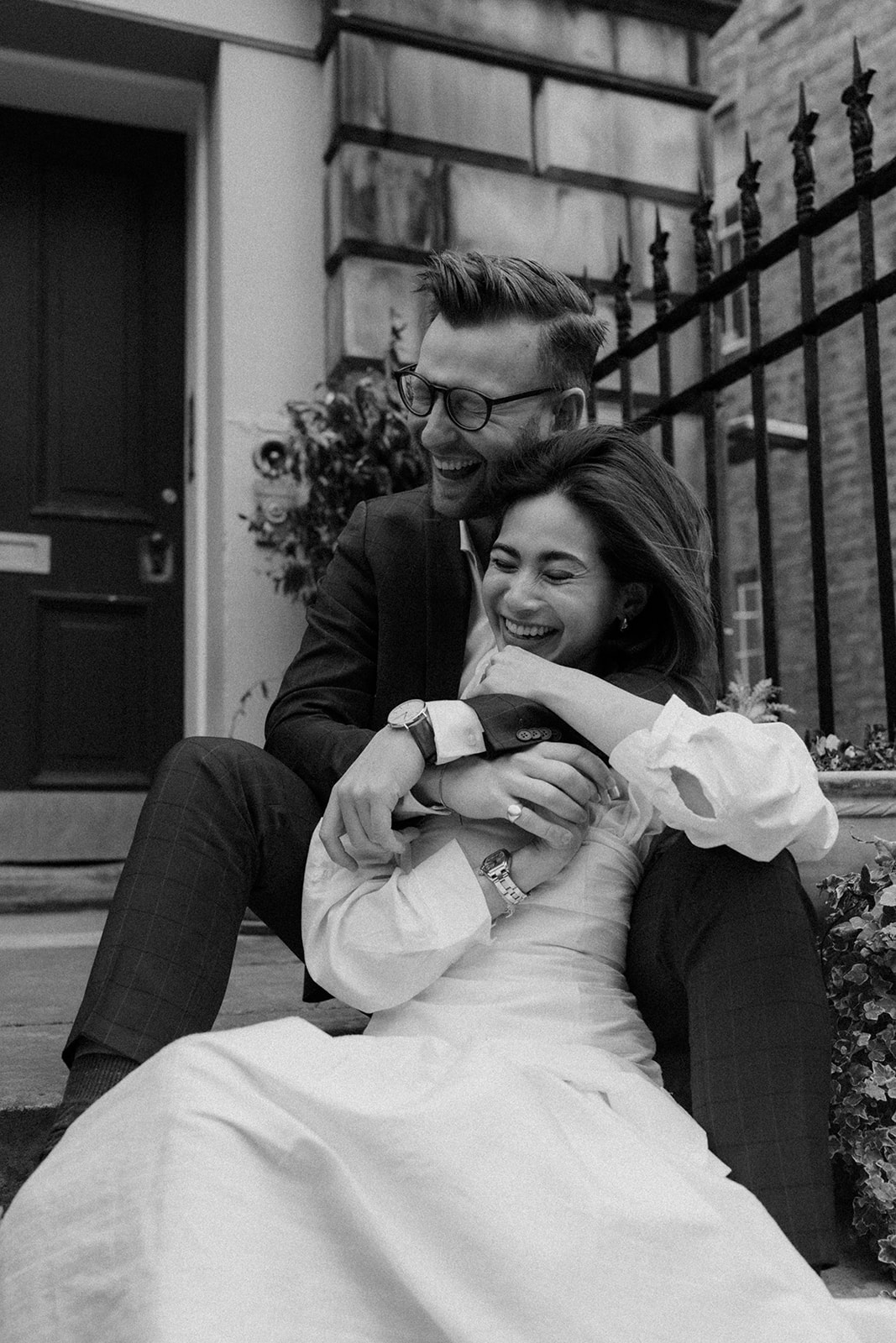 Couple captured in a documentary-style engagement photo, walking through the streets of Edinburgh.