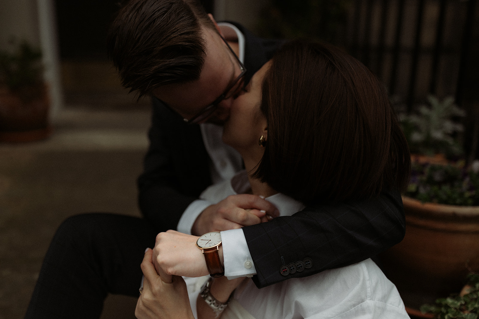 Documentary-style engagement photo of a couple walking through Edinburgh's romantic streets