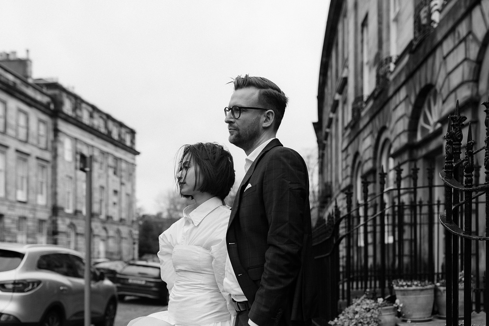 Editorial engagement session featuring a couple strolling hand-in-hand through Edinburgh’s historic streets