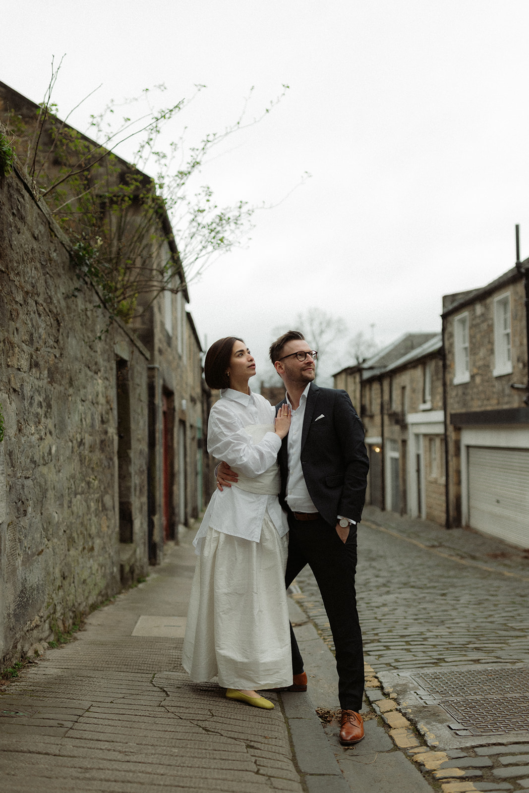 Intimate documentary engagement session in Edinburgh, showcasing a couple walking together through the city.