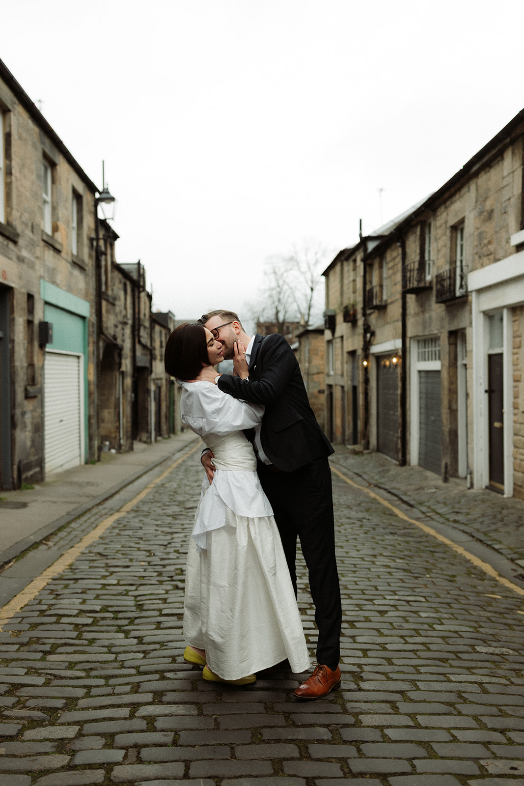 Couple walking through Edinburgh’s streets, captured in a documentary-style engagement session.