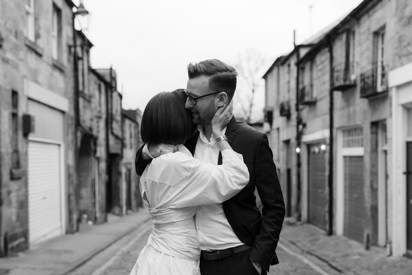 Documentary-style engagement photography, featuring a couple walking hand-in-hand through Edinburgh.