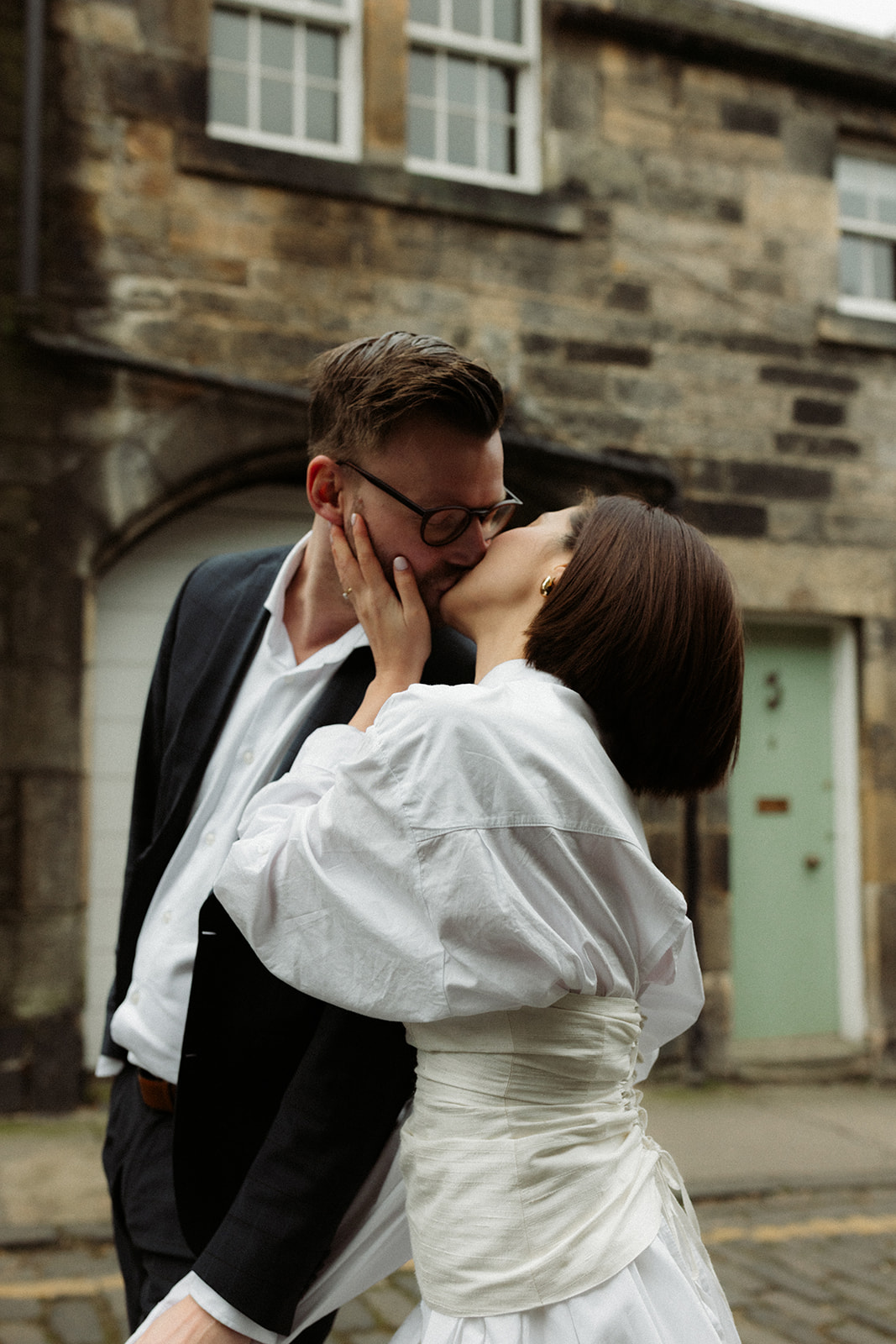 Couple walking through Edinburgh’s charming streets, photographed in a documentary engagement style