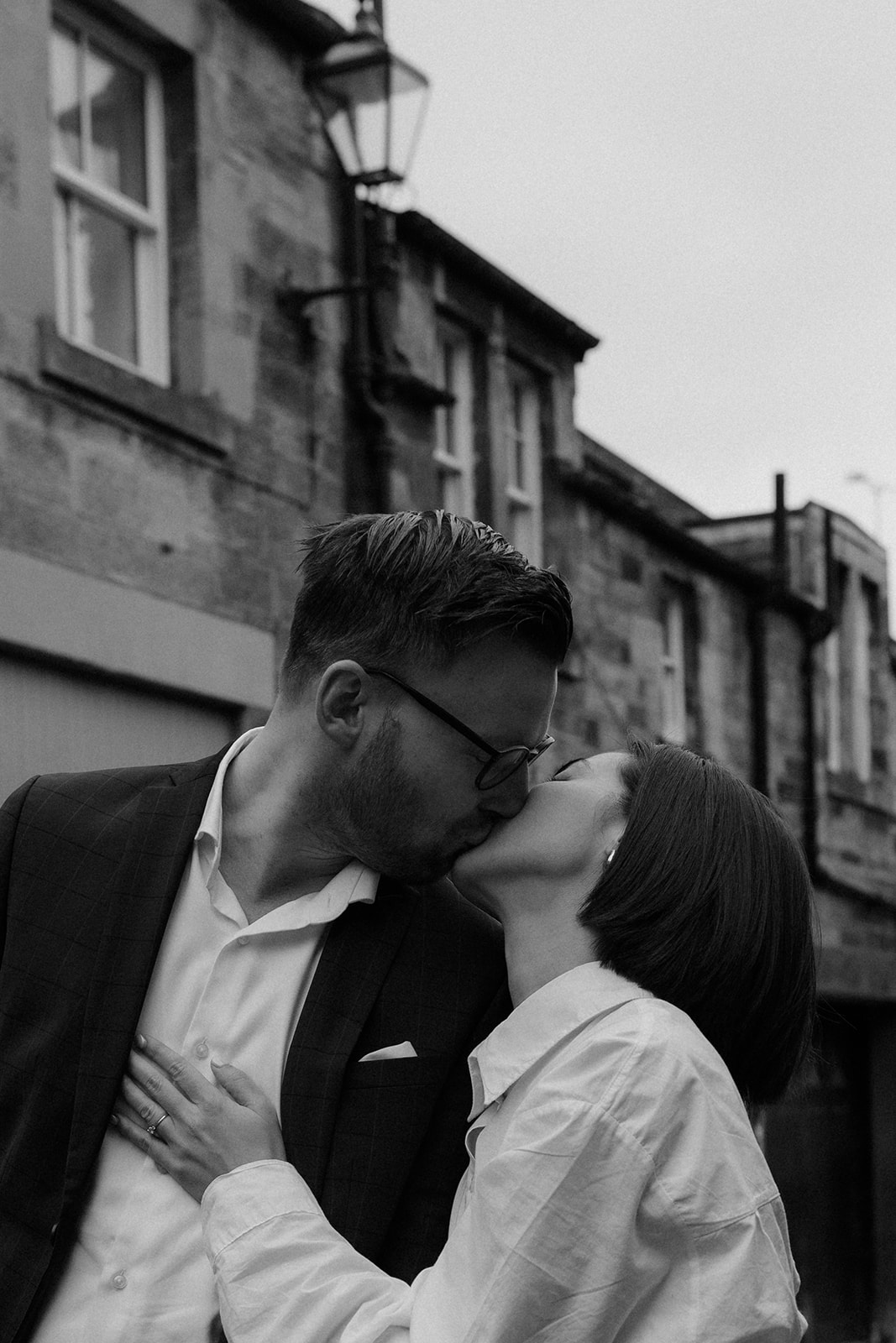 Natural and candid editorial engagement session in Edinburgh with a couple walking through the city.