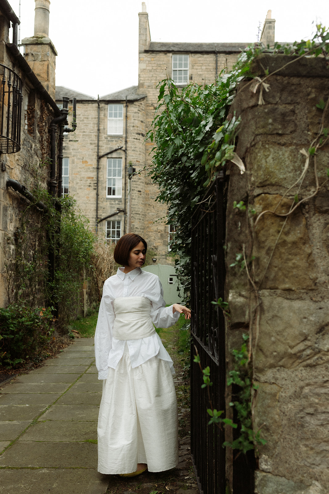 Romantic documentary engagement session capturing a couple walking hand-in-hand through Edinburgh’s streets.