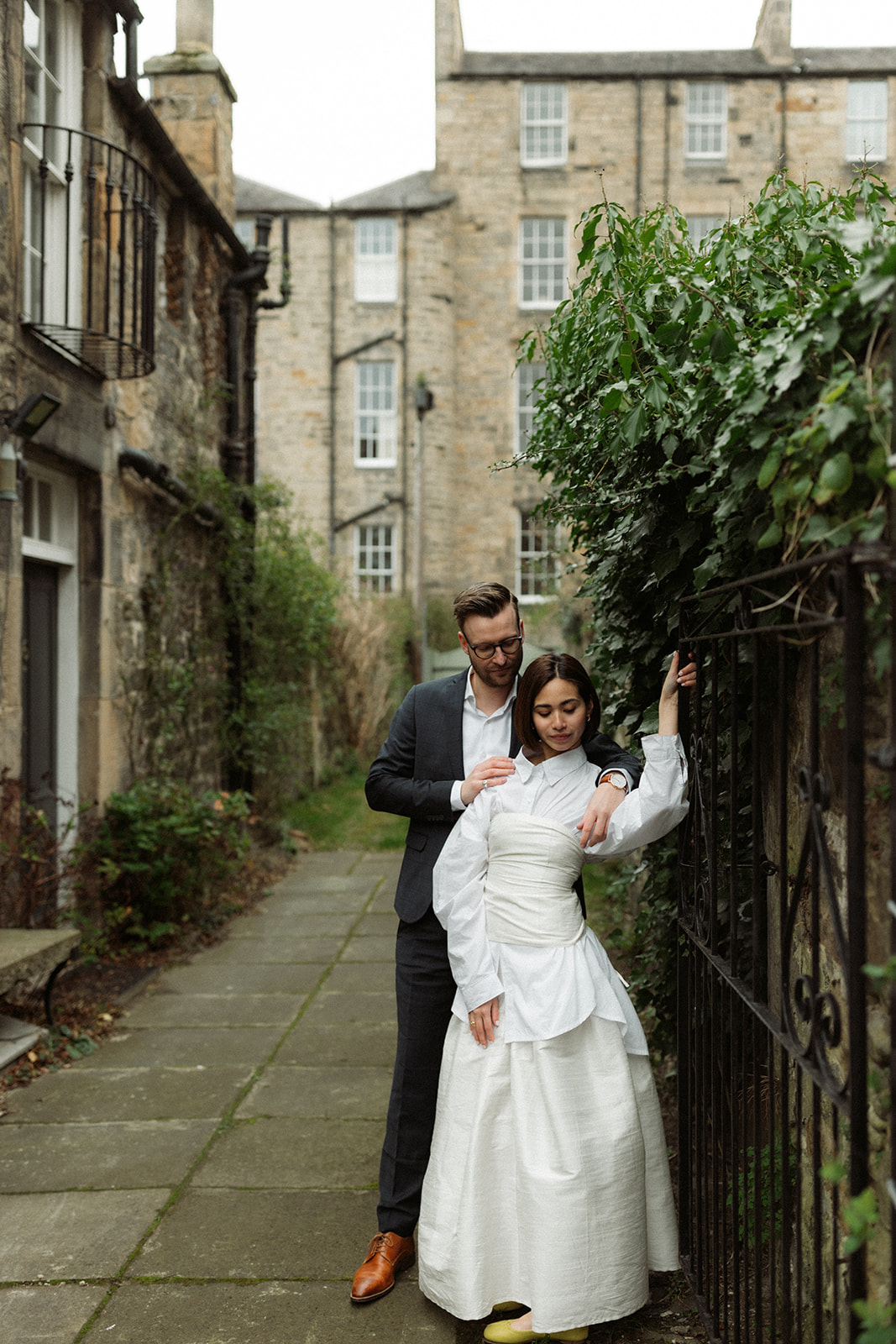 Couple captured walking through Edinburgh’s iconic streets, photographed in an editorial-style engagement session.