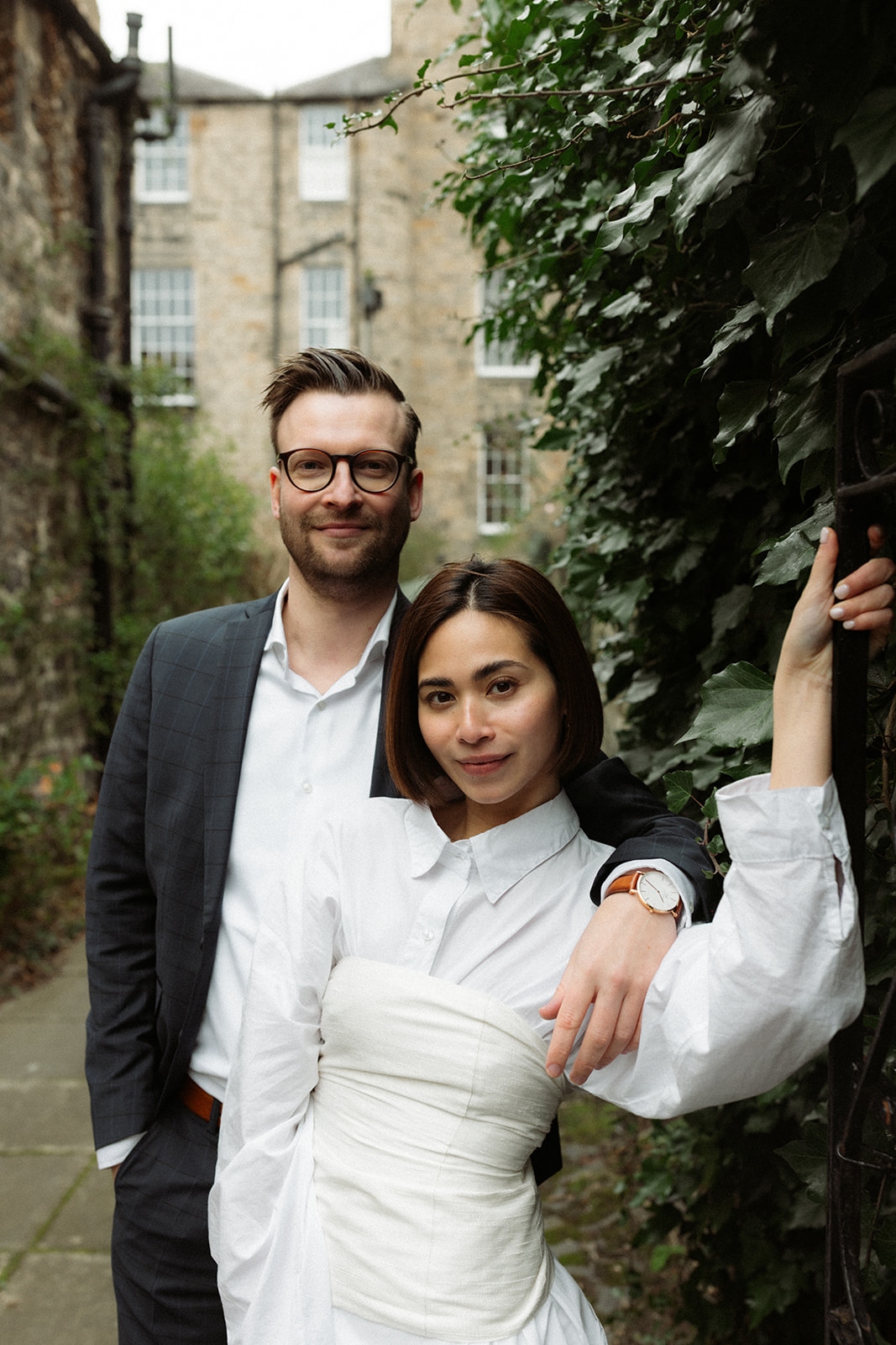 Candid and intimate engagement moment as a couple walks through Edinburgh, captured in a documentary style.
