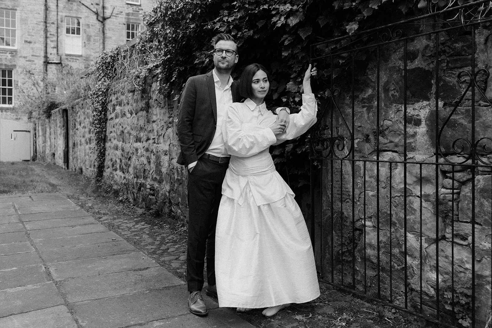 Editorial engagement session in Edinburgh, documenting a couple walking together through scenic streets.