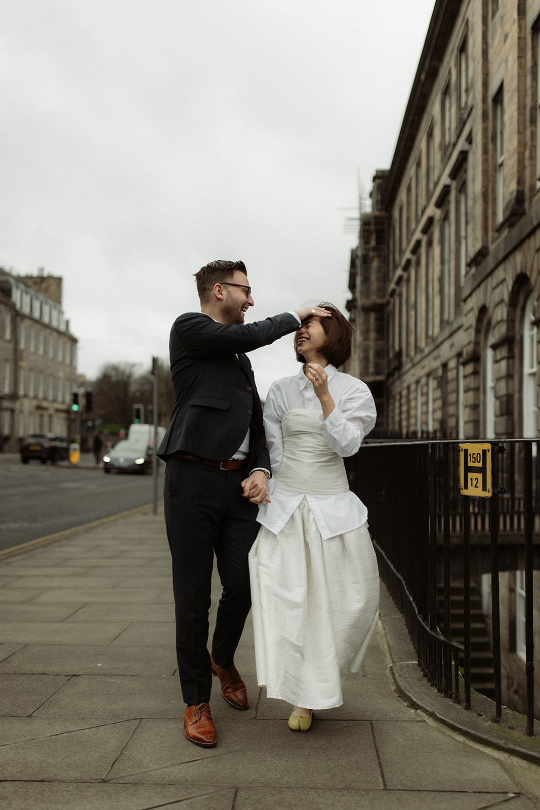 Documentary-style engagement session with a couple strolling through Edinburgh's historic streets.