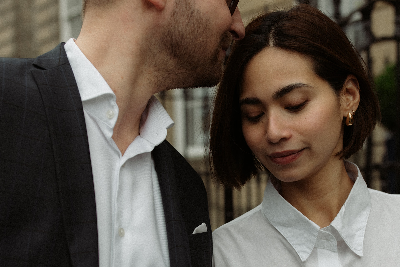 Candid moment from an editorial engagement session, capturing a couple walking through Edinburgh's scenic streets