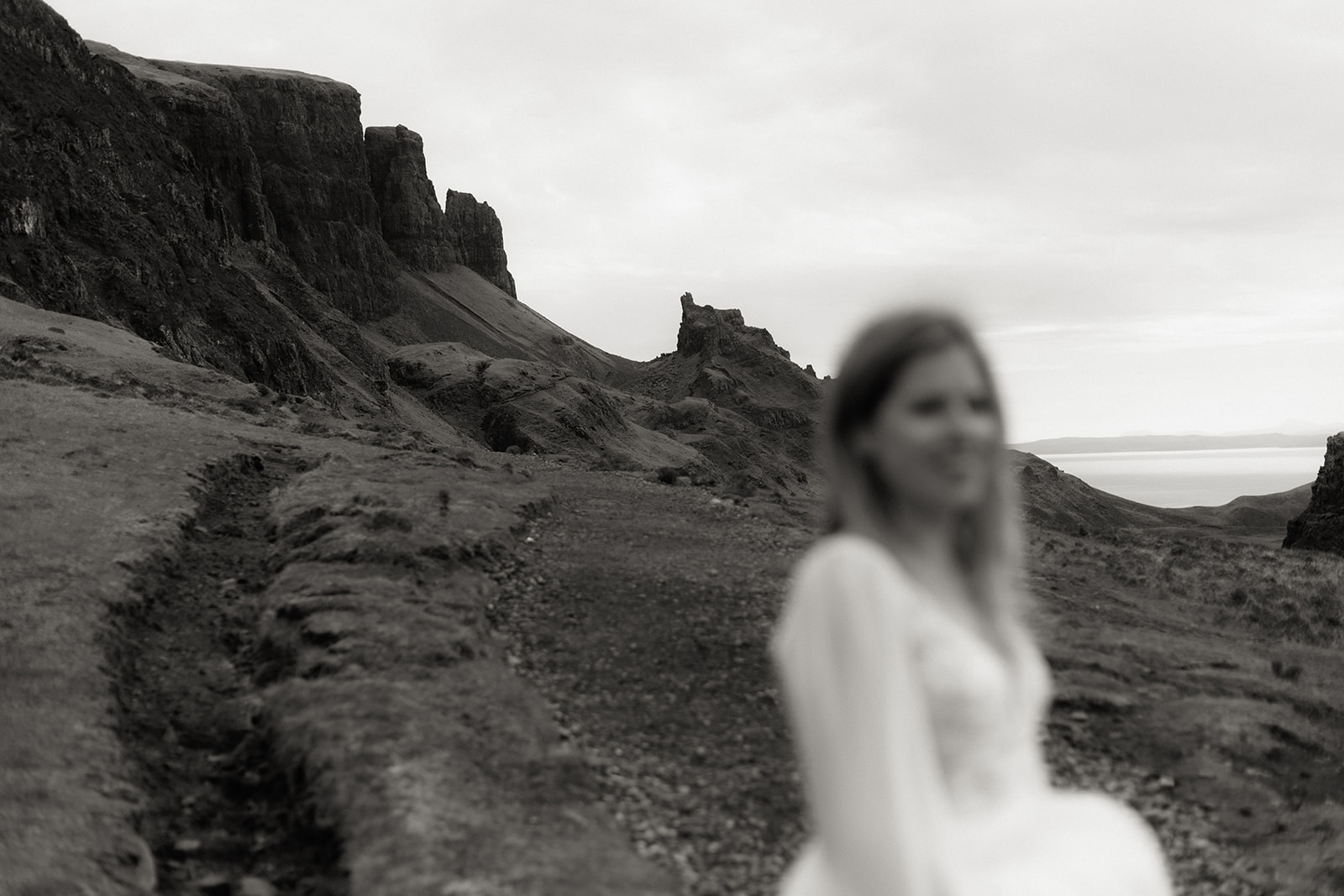 Isle of Skye landscape in sharp focus with bride softly blurred in the foreground