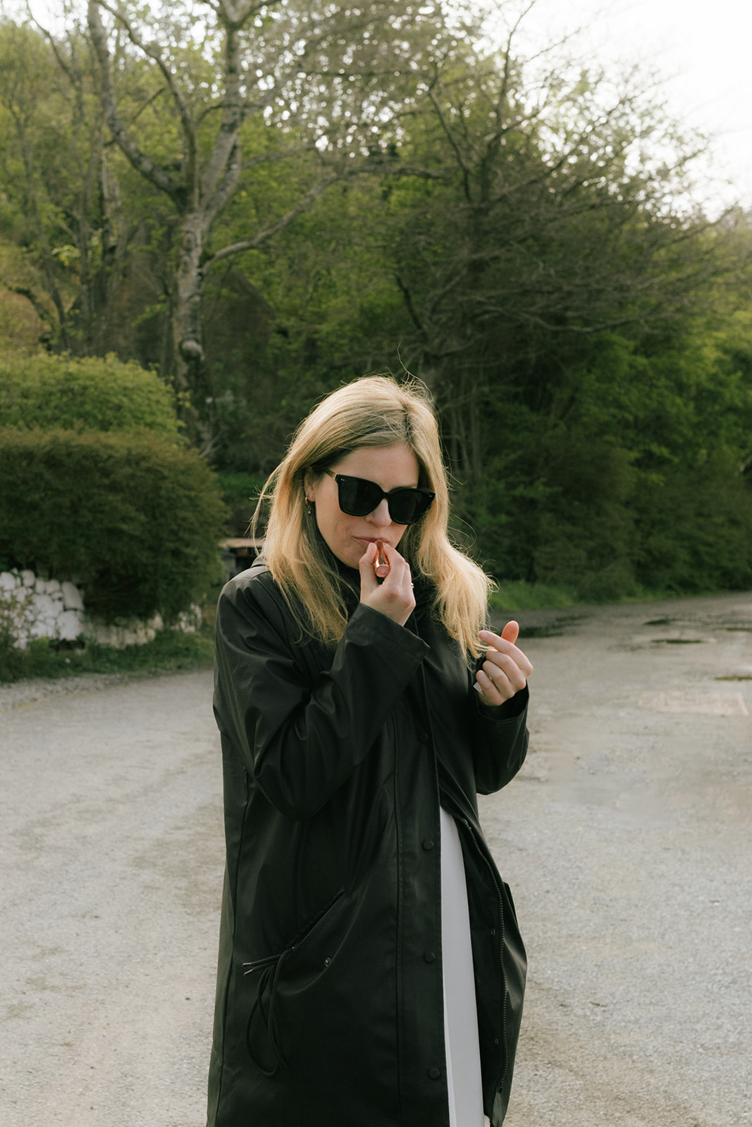 Bride touching up her lipstick during Isle of Skye elopement photoshoot
