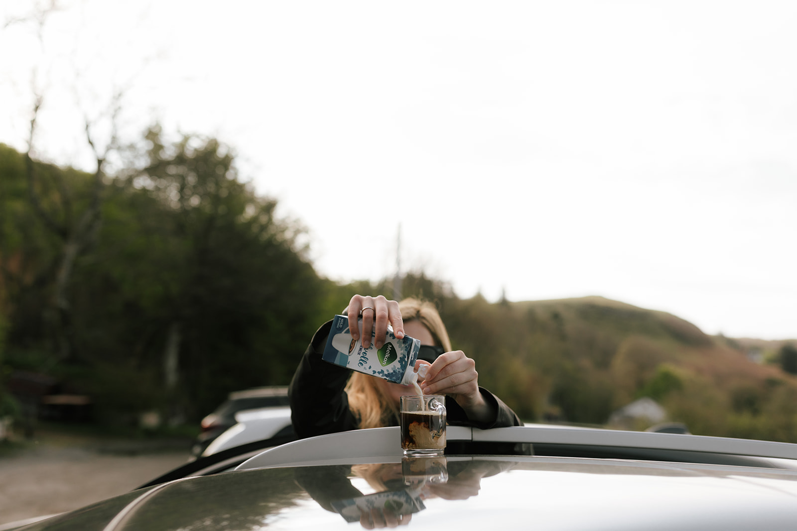 Bride pouring milk into coffee during Isle of Skye elopement morning