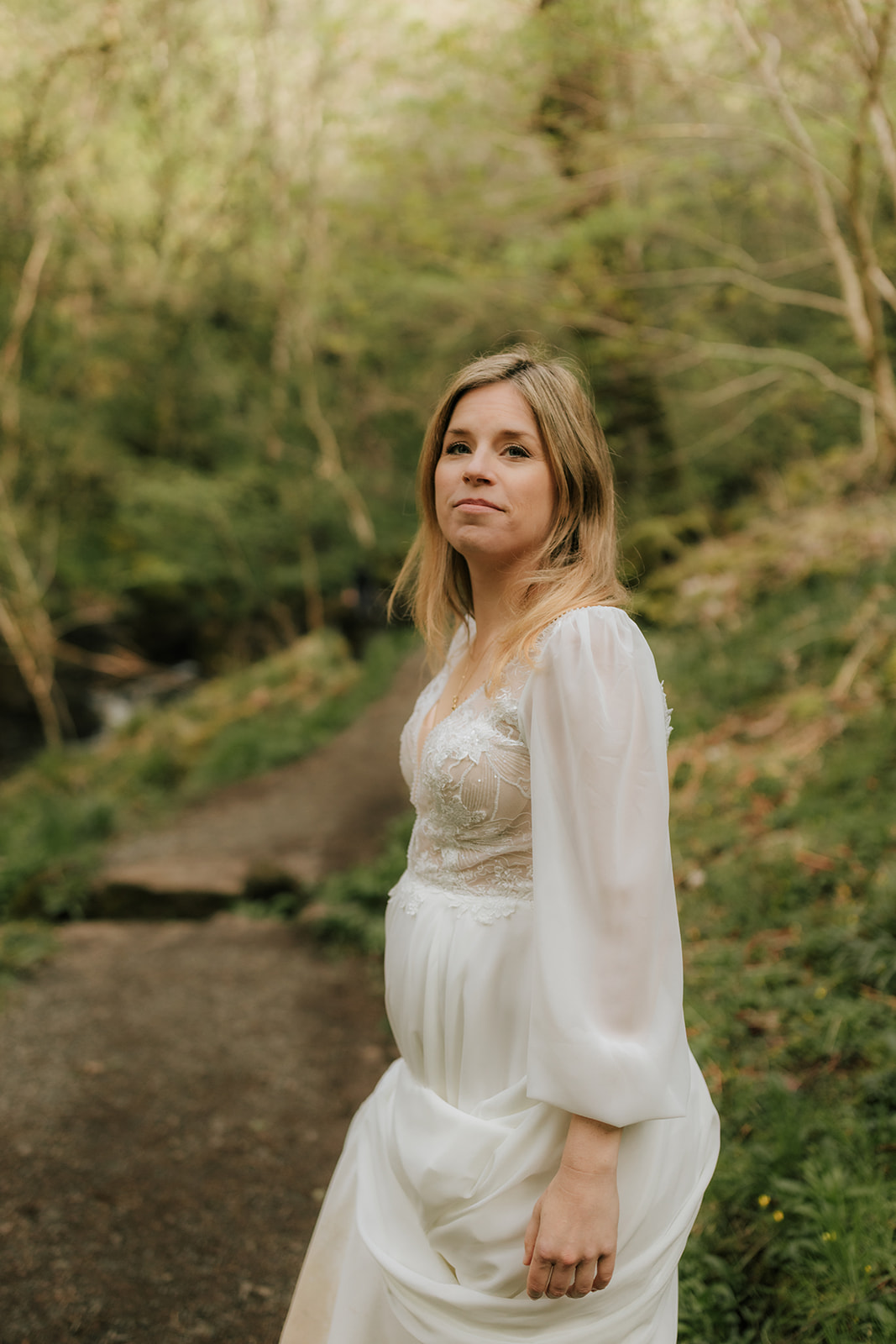 Bride posing gracefully near a waterfall on the Isle of Skye
