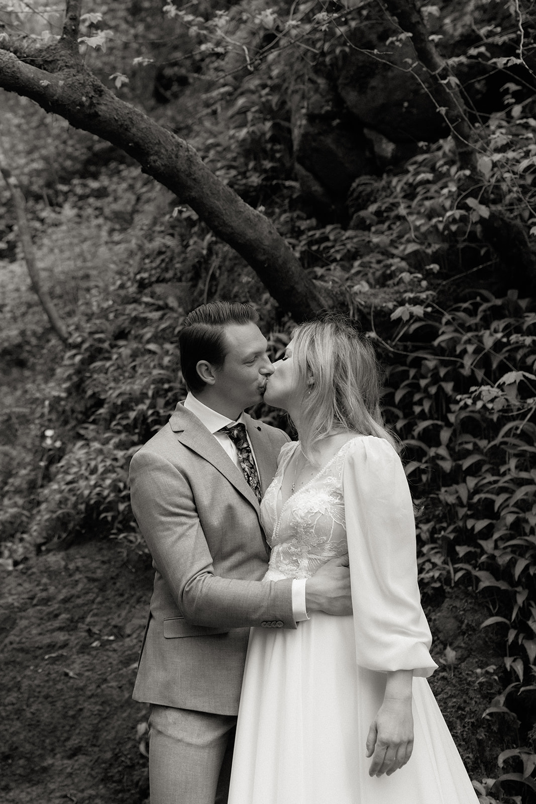 Couple sharing a kiss surrounded by wild garlic during their Isle of Skye elopement