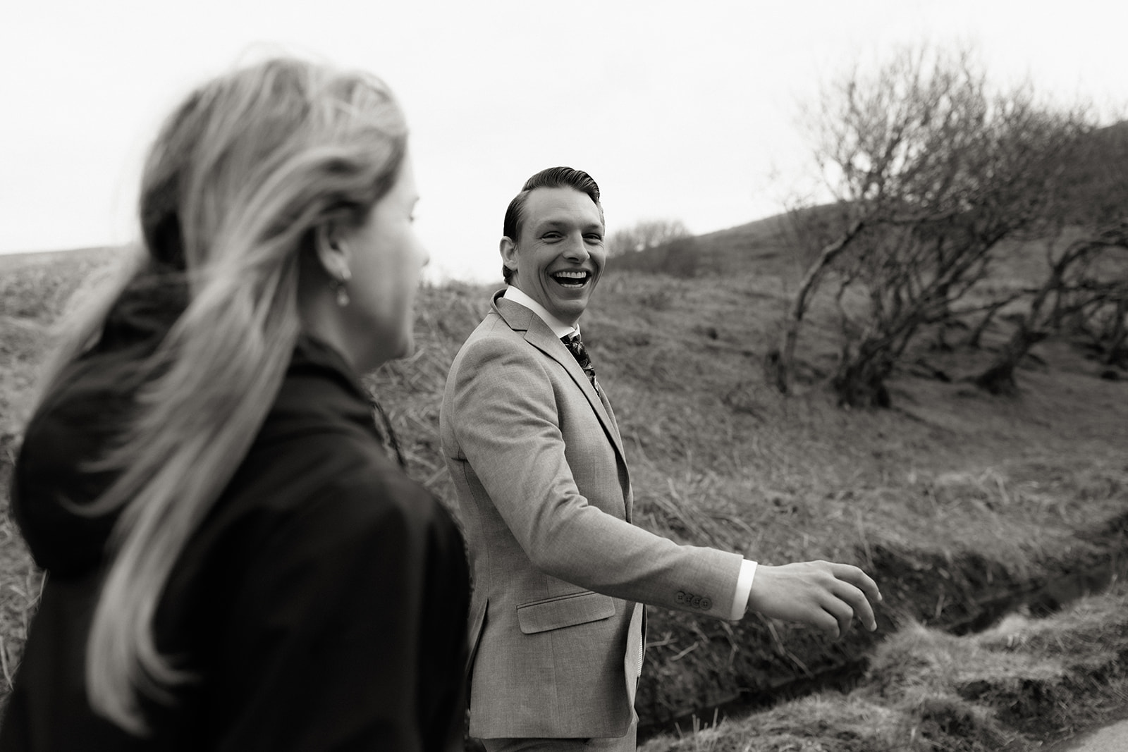 Groom laughing while walking during Isle of Skye elopement