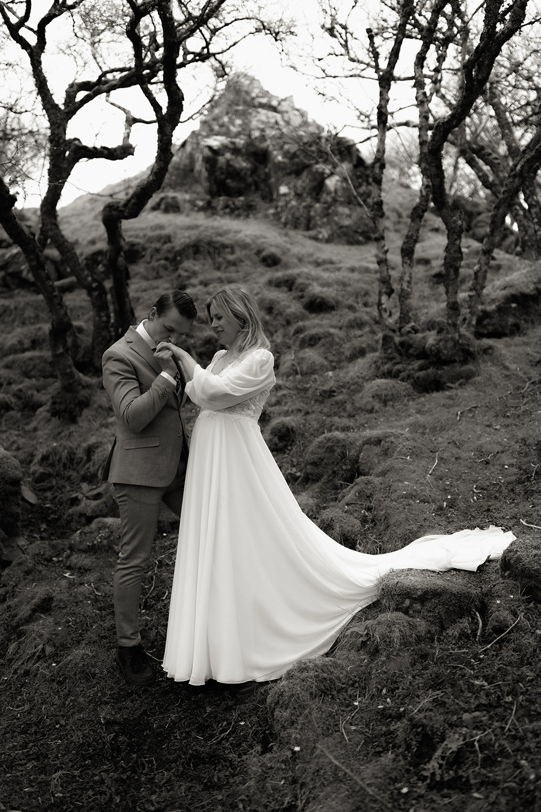 Eloping couple embracing at the Fairy Glen, Isle of Skye