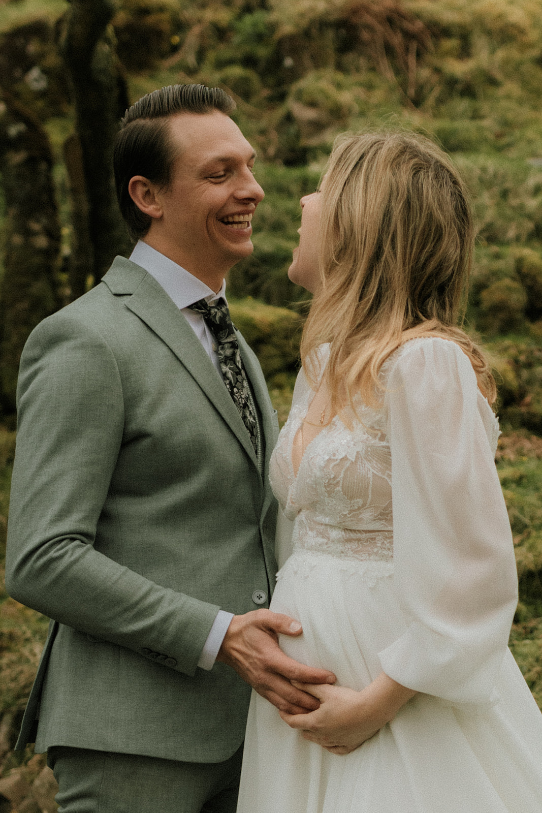 Close-up of couple’s tender embrace surrounded by trees at the Fairy Glen, Isle of Skye