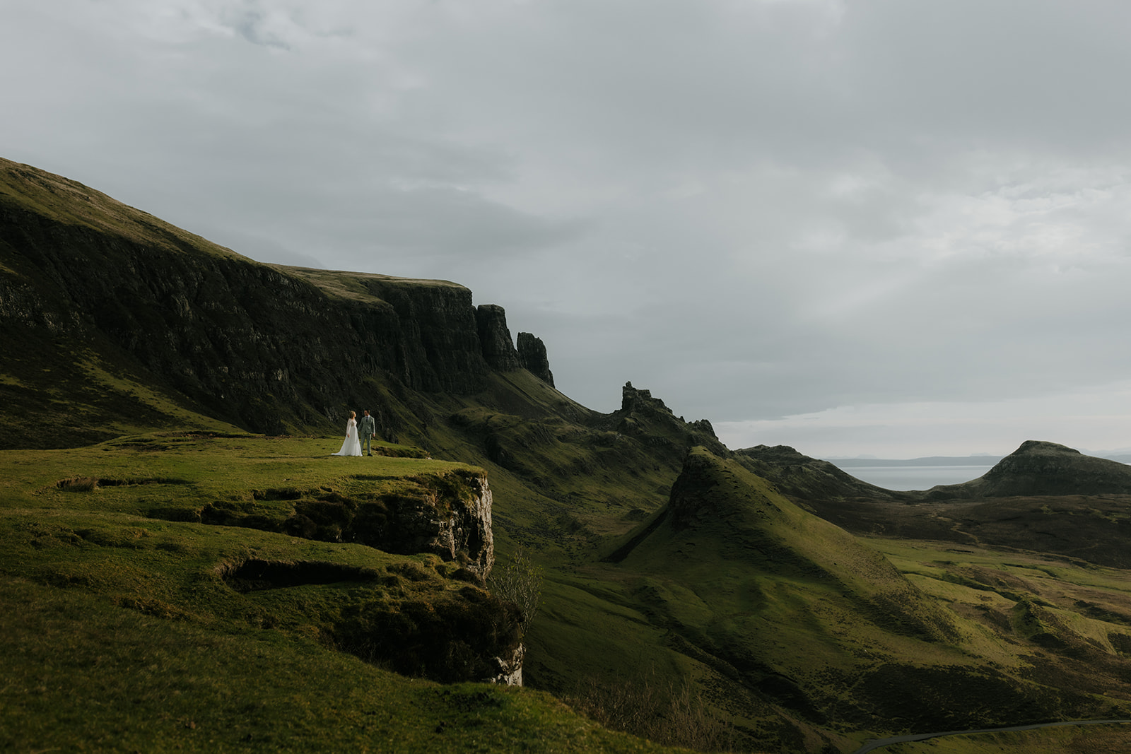 Couple standing in sunlight at the Quiraing during their Isle of Skye elopement