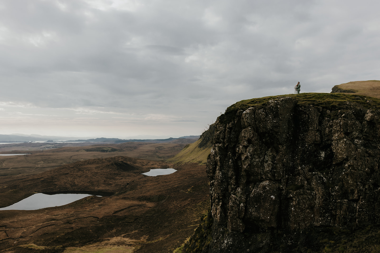 Couple sharing a quiet moment during their Isle of Skye elopement, surrounded by natural landscape