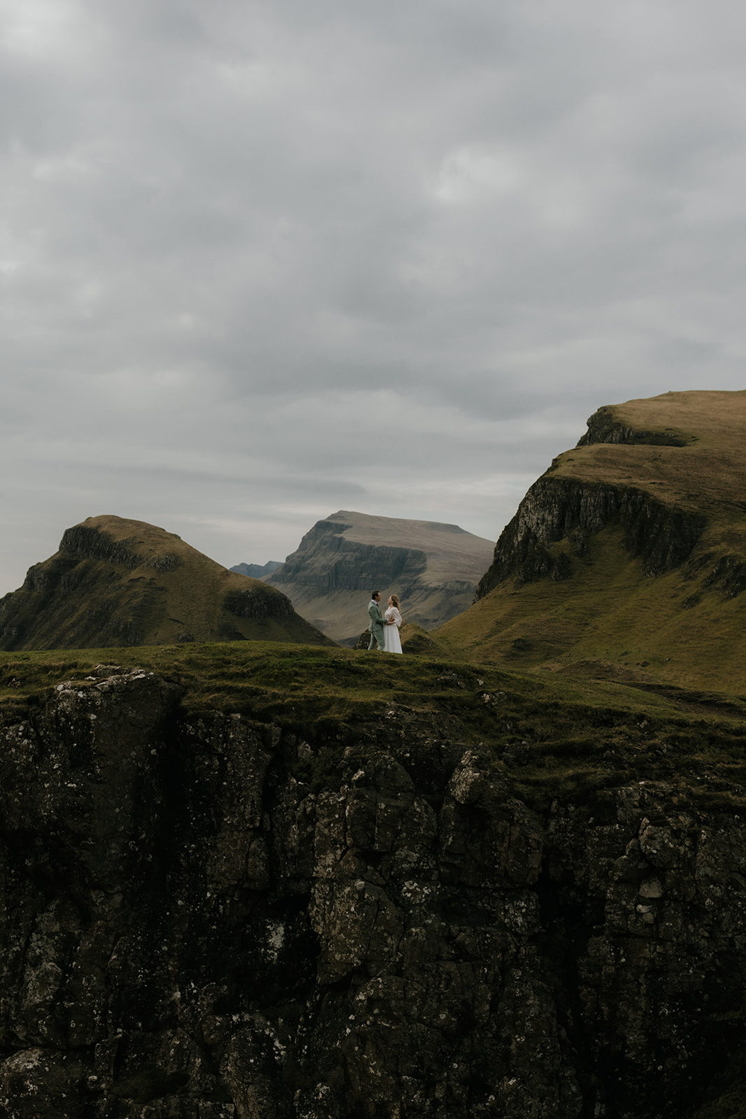 Environmental portrait of eloping couple surrounded by the rugged landscape of the Isle of Skye