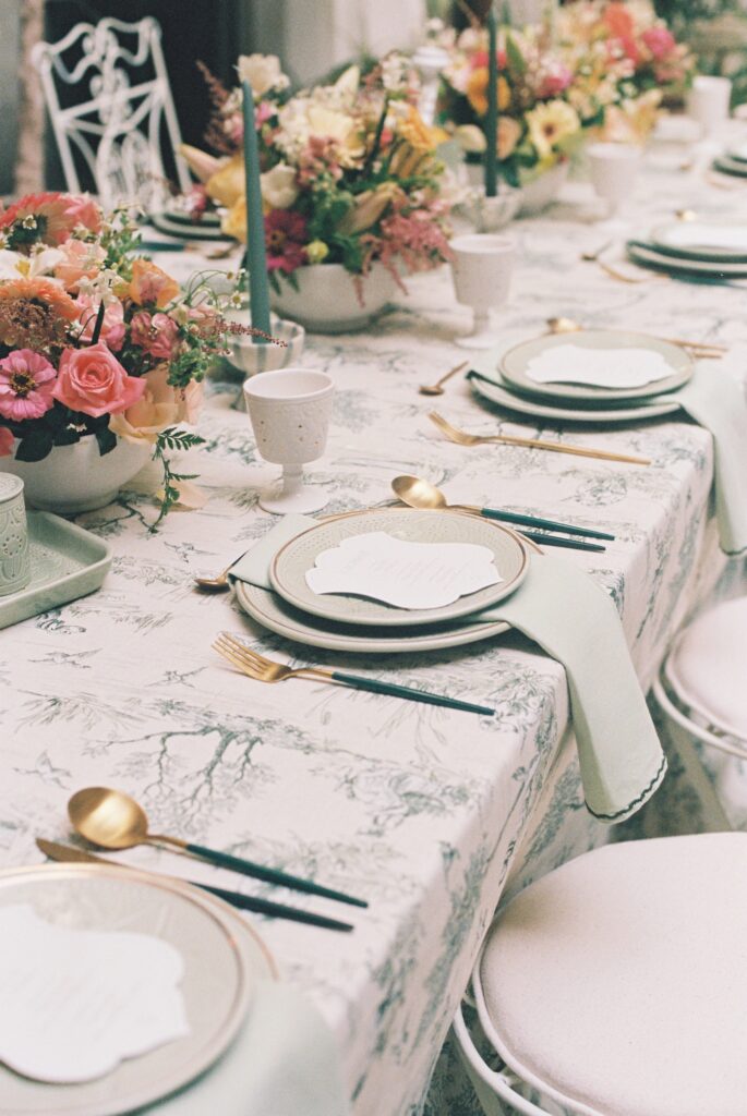 Elegant wedding table setting with blush florals at a Marrakesh riad, photographed on 35mm film.