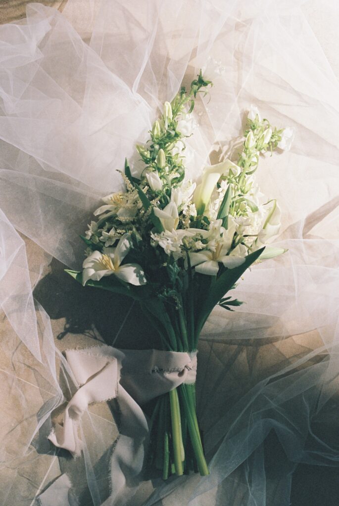 White and green bridal bouquet in soft tulle light, Marrakesh wedding, 35mm film