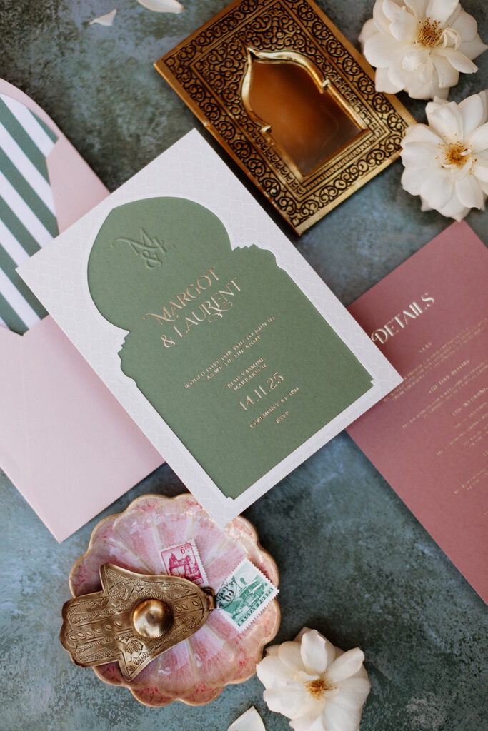 Moroccan-inspired wedding stationery in green and blush tones.