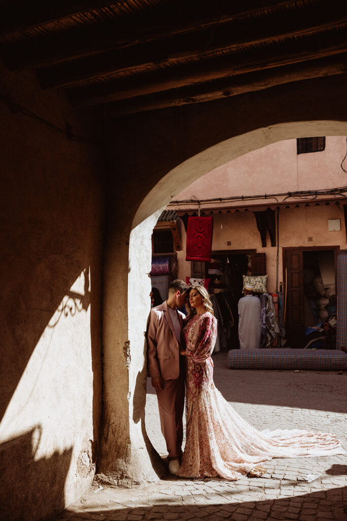 Couple embracing in shaded Marrakesh archway