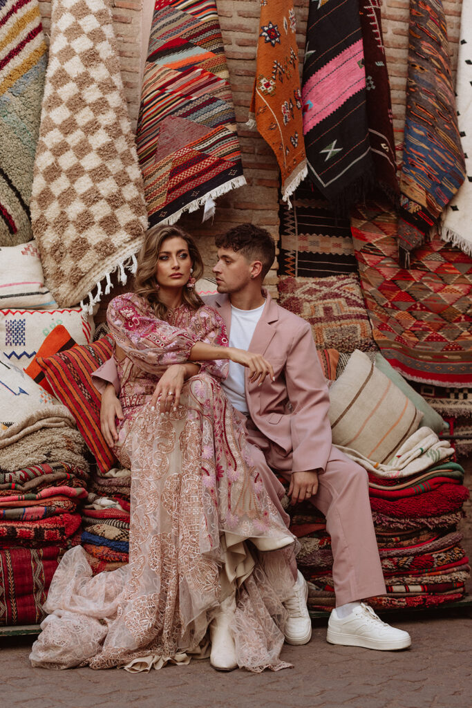 Couple posing in Marrakesh market with rugs