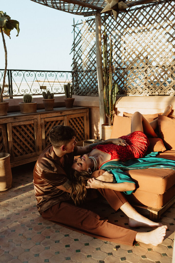 Bride and groom relaxing on a Marrakesh rooftop terrace with city views