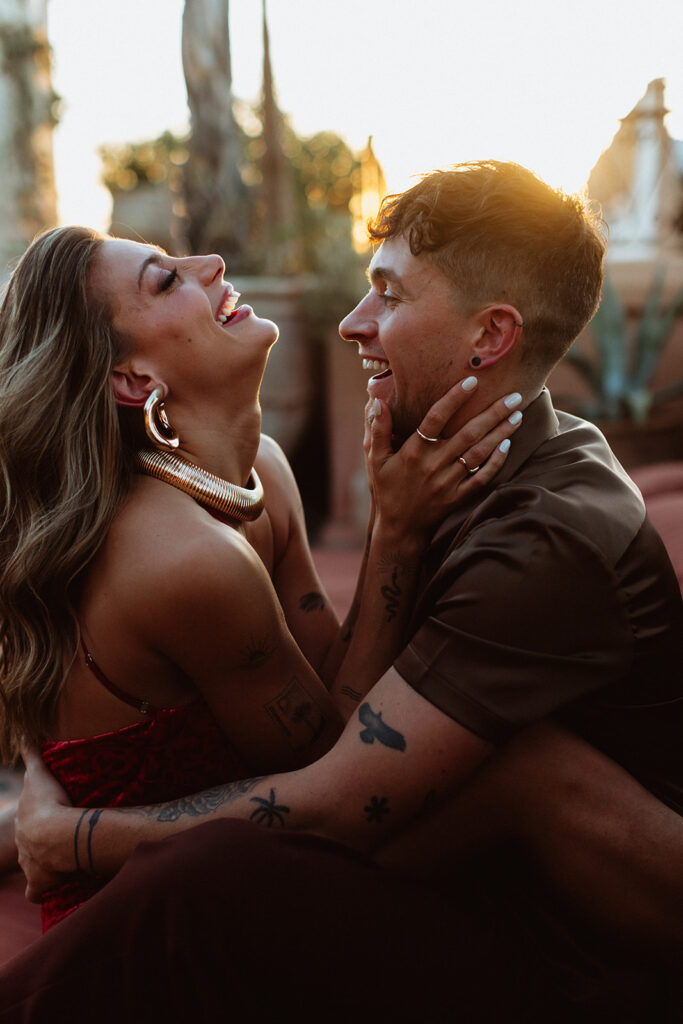 Couple laughing together in golden Marrakesh sunset light