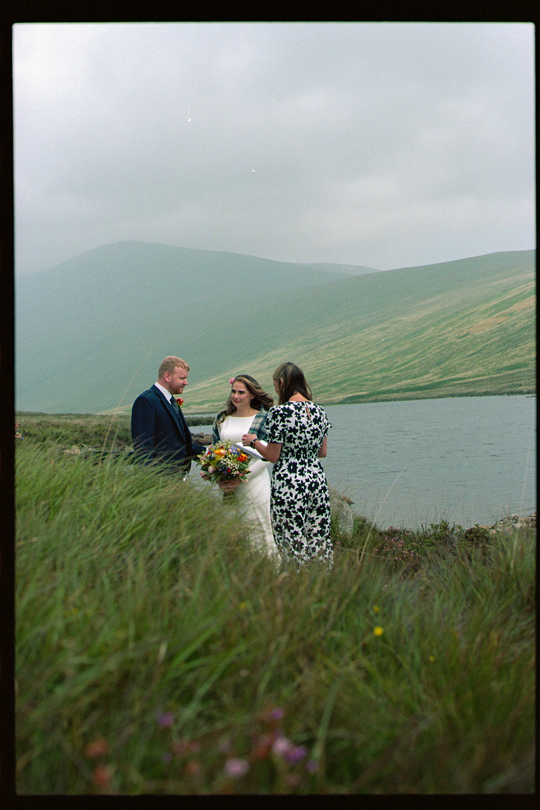 Bride and groom with celebrant by Loch Iorsa, Isle of Arran elopement on 35mm film